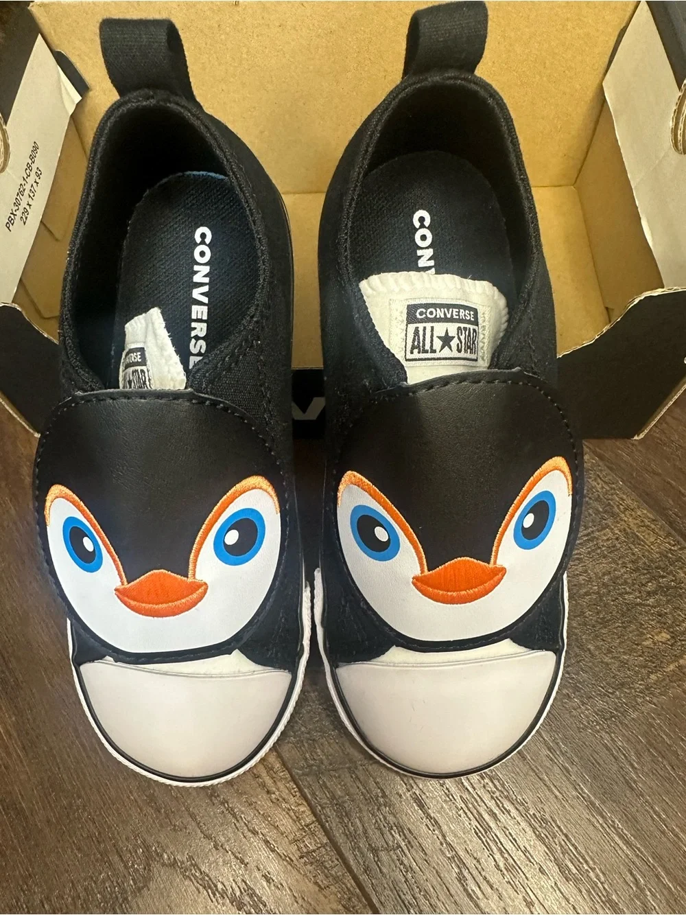 Converse Kids Black Penguin Slip-On Sneakers with Blue Eyes and Orange Beak